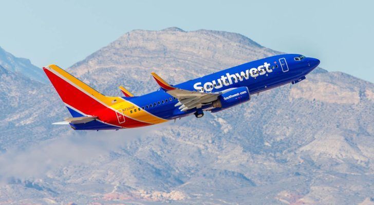 Southwest (LUV) plane mid-flight with mountains in background