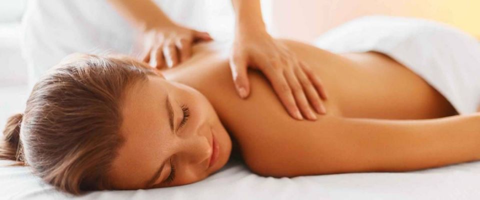 Female enjoying relaxing back massage in cosmetology spa centre. Body care, skin care, wellness, wellbeing, beauty treatment concept.