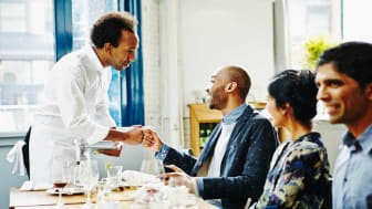 picture of chef greeting people in his restaurant