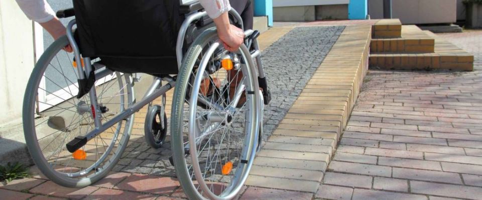 Woman in a wheelchair using a ramp