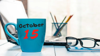 picture of desk with &quot;October 15&quot; written on a coffee mug