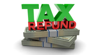 picture of the words &quot;Tax Refund&quot; on top of a stack of money