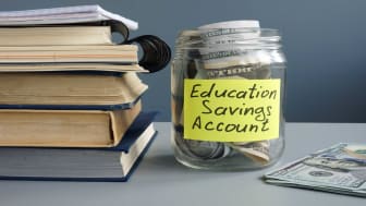 picture of a jar with money in it labeled &quot;Education Savings Account&quot;