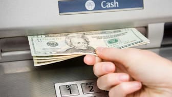 Withdrawing money at an ATM.